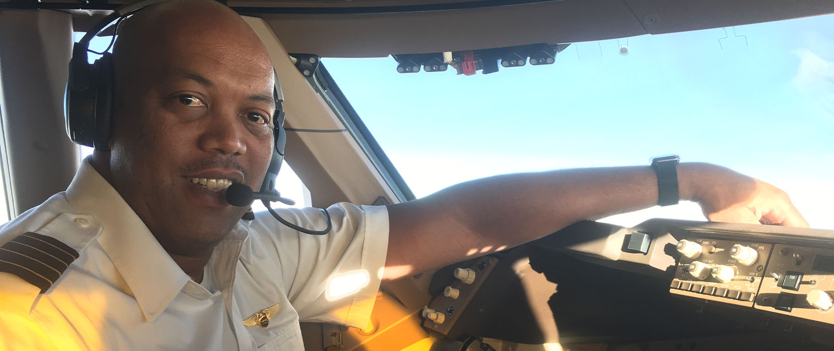 Airline captain Anderson Johnson III sits in the cockpit of his aircraft