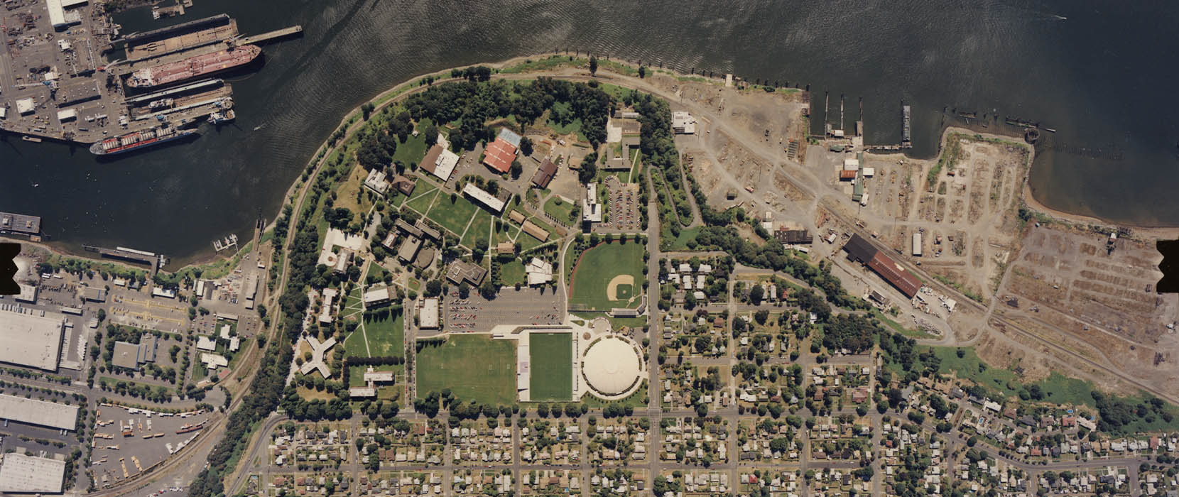 Aerial view of UP campus and North Portland area, 1990. The Franz River Campus--pictured here to the right of campus--was known as Triangle Park, and still had industrial buildings intact.