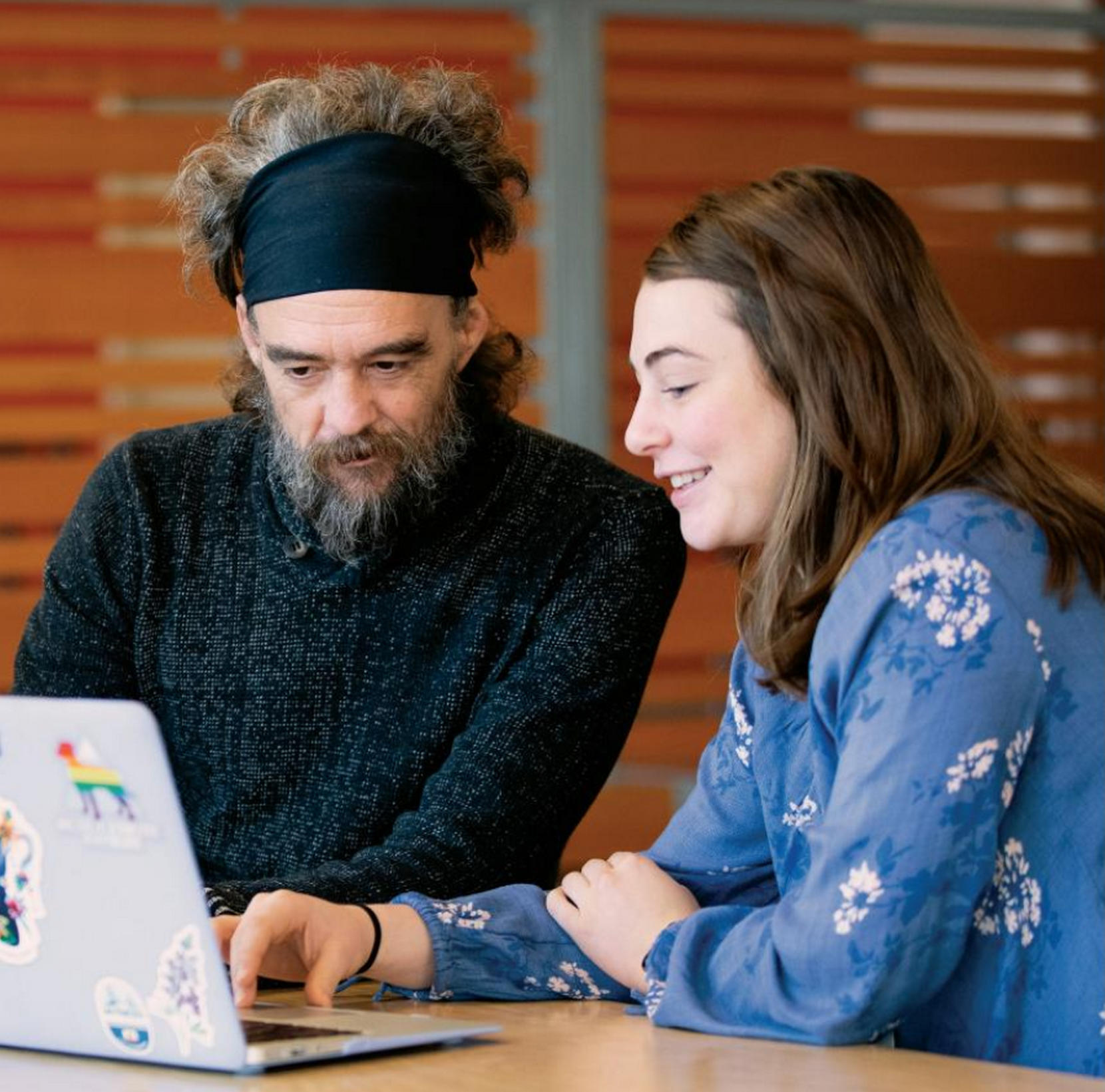 A student nurse from UP (right) consults with a Blanchet House resident (left)
