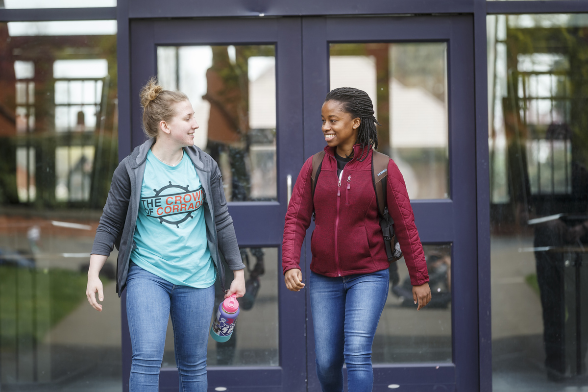 two-students-exiting-a-building