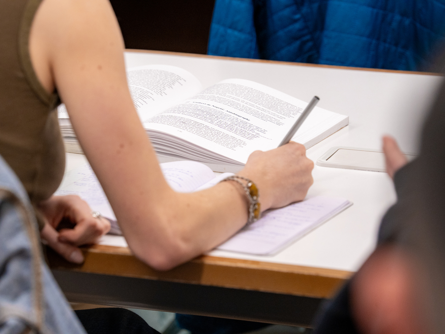 Photo of student writing in notebook.